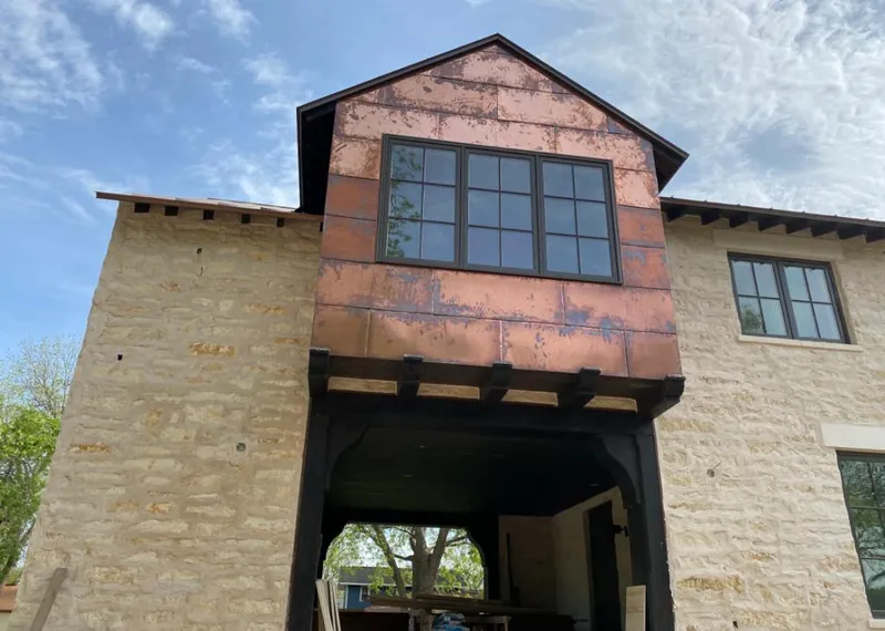 Copper metal panel facade on a stone building for Metal Roof Coating in Farmington Hills