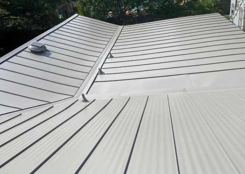 Solar attic fan installed on a metal roof for Roof Ventilation in Farmington Hills